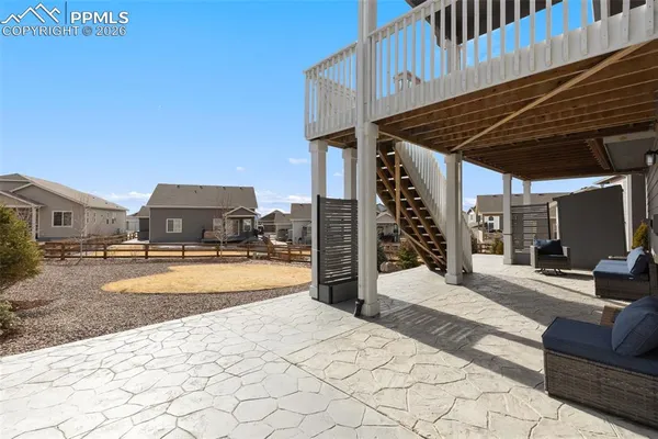 a view of a house with backyard and sitting area