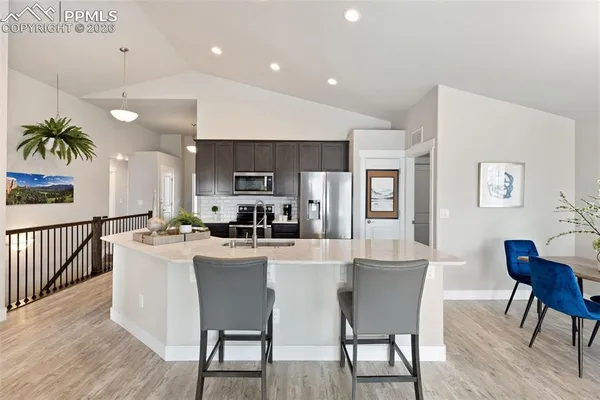 a dining room with furniture and a kitchen view