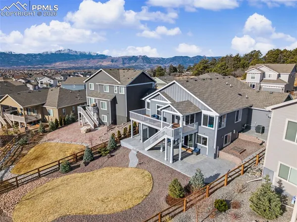 an aerial view of a house with a big yard