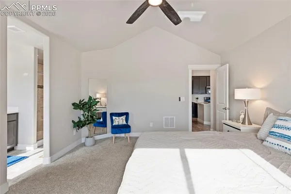 a bedroom with a bed and a potted plant