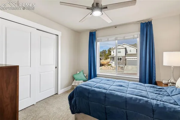 a bedroom with a bed and a large window