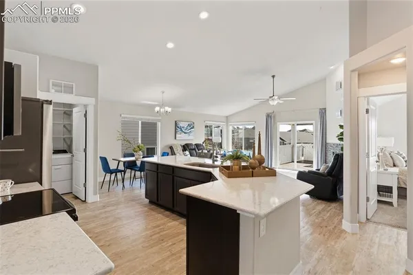 a large kitchen with a table and chairs