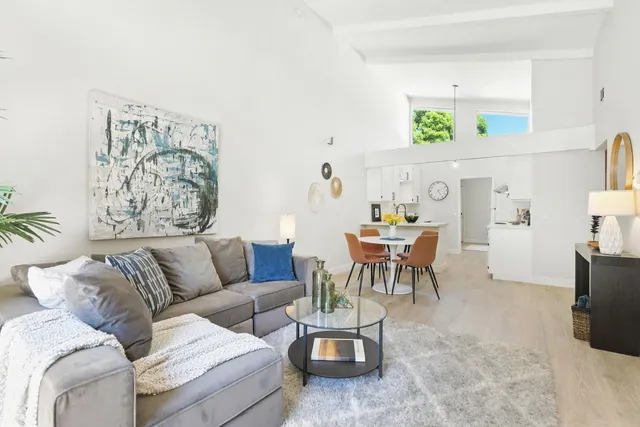 a living room with furniture and painting on the wall