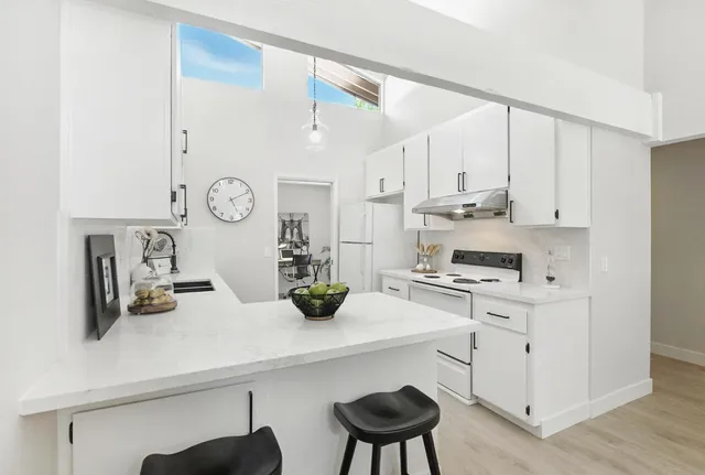 a kitchen with a sink cabinets and wooden floor