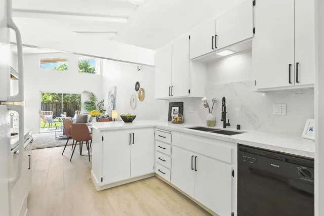 a kitchen with white cabinets and white appliances