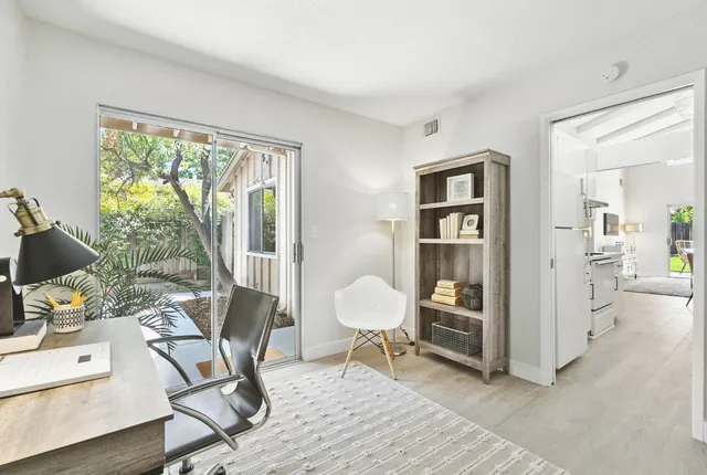 a workspace with wooden floor and a window