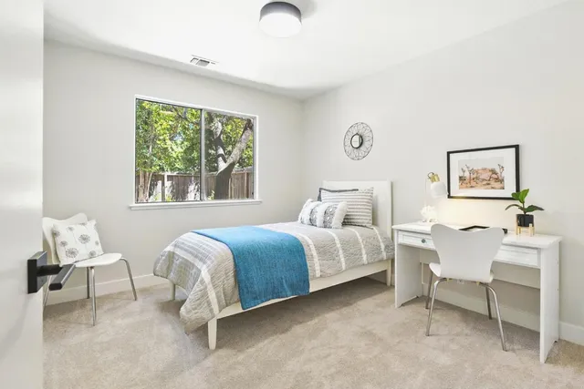 a spacious bedroom with a bed and a window