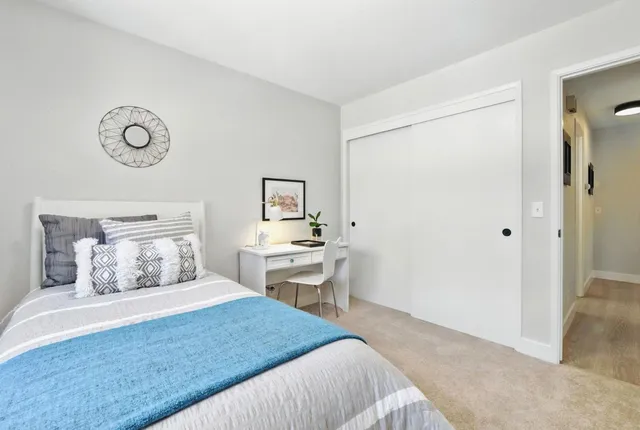 a bedroom with a bed and a table in it