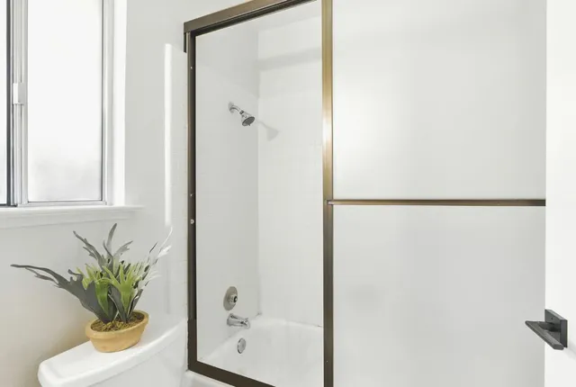 a bathroom with a shower curtain a mirror and a sink