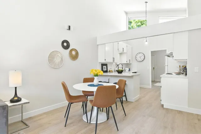 a dining room with furniture and a clock