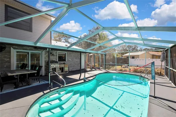 a view of a swimming pool with a patio
