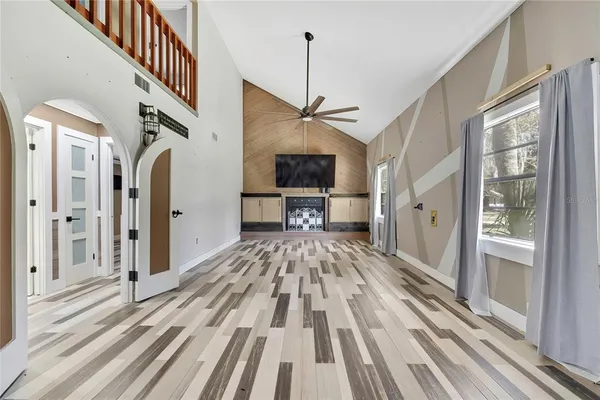 a view of a hallway view with wooden floor and staircase