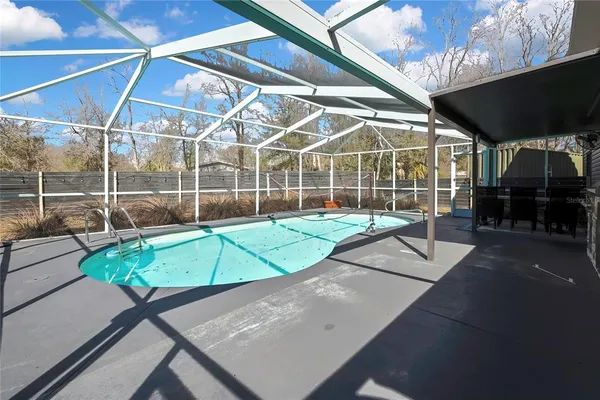 a view of a room with table and chairs