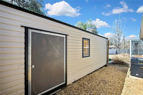 a view of a house with a backyard