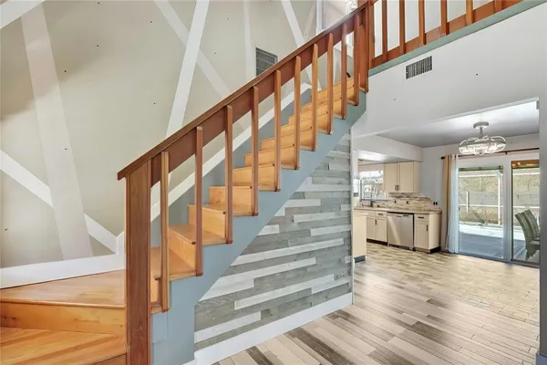 a view of entryway and hall with wooden floor