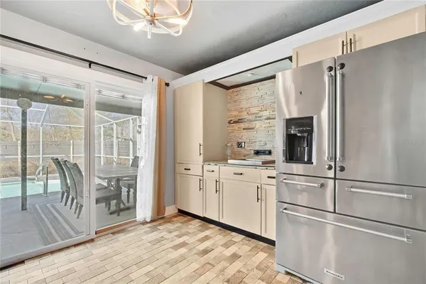 a kitchen with white cabinets and a refrigerator