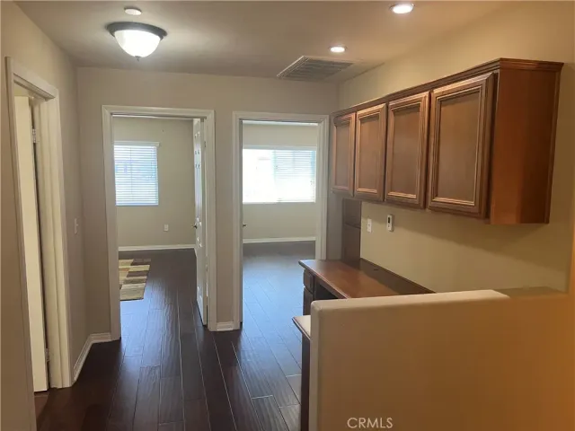 an empty room with wooden floor & closet area