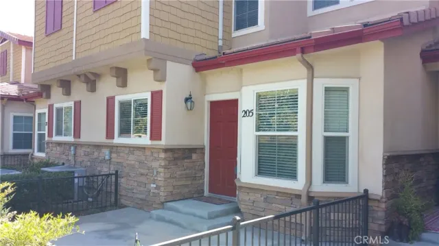 a view of an empty room with wooden floor and a fire place