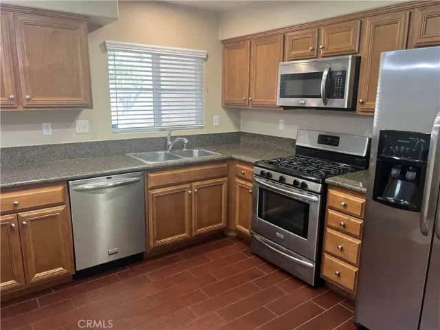 a kitchen with granite countertop a sink and cabinets