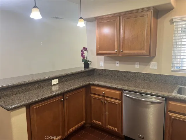 a kitchen with stainless steel appliances granite countertop a refrigerator stove and sink