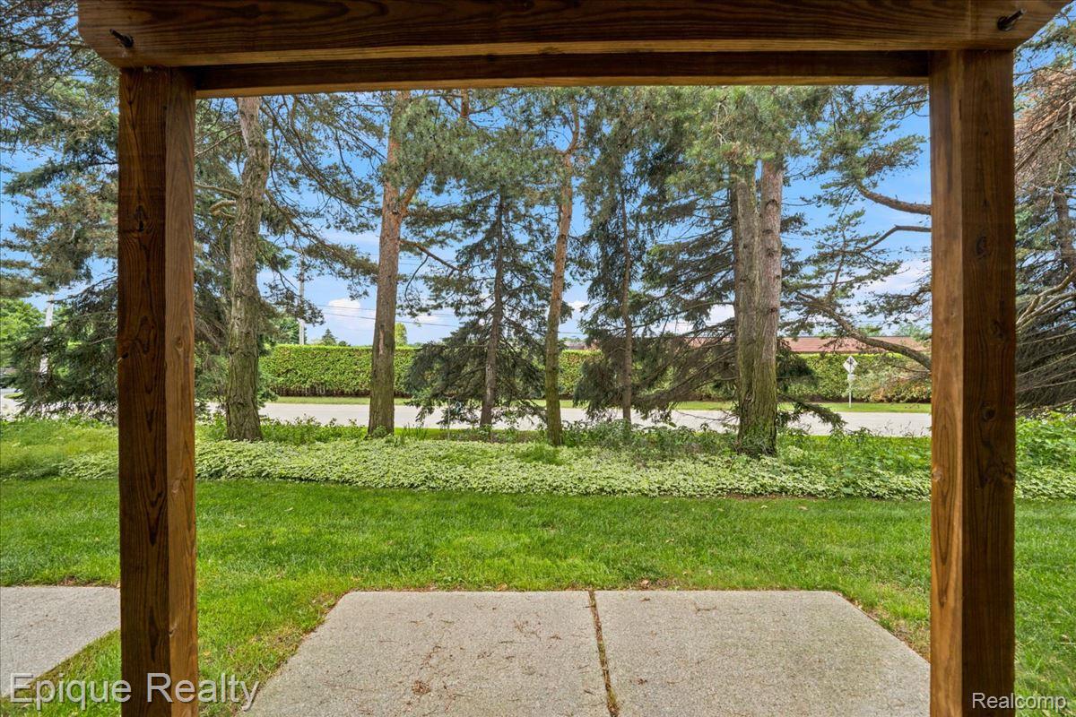 26 Kirks Court Rochester, MI 48309 - Photo 44 of 44 Covered outdoor patio space with concrete flooring, framed by substantial wood beams