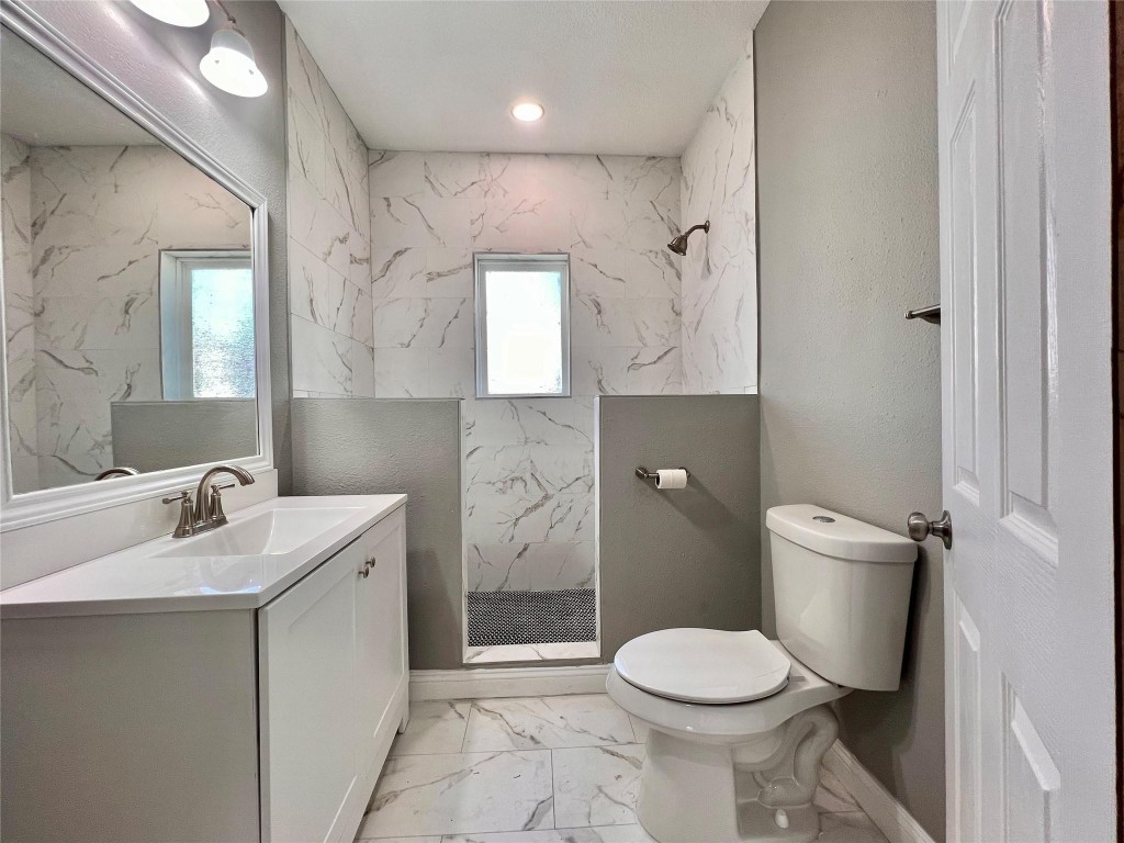 4106 Robertson Street Houston, TX 77009 - Photo 13 of 14 a bathroom with a toilet sink and mirror