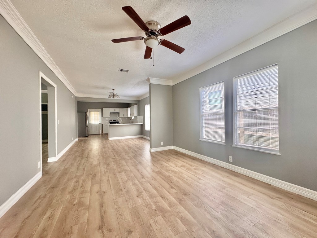 4106 Robertson Street Houston, TX 77009 - Photo 4 of 14 a view of empty room with wooden floor and ceiling fan