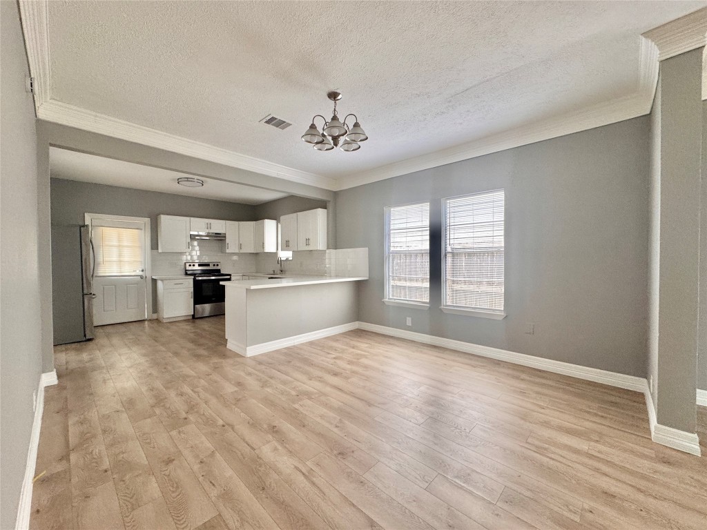 4106 Robertson Street Houston, TX 77009 - Photo 6 of 14 a view of an empty room with kitchen and window