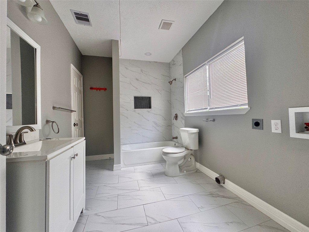 4106 Robertson Street Houston, TX 77009 - Photo 9 of 14 a bathroom with a toilet sink and mirror