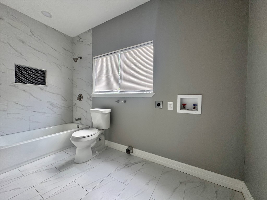 4106 Robertson Street Houston, TX 77009 - Photo 10 of 14 a white toilet sitting next to a bathroom sink