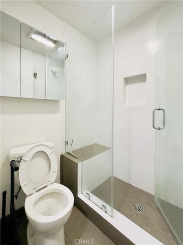 a bathroom with a granite countertop toilet sink and shower