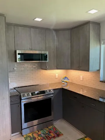 a kitchen with granite countertop a stove and a sink