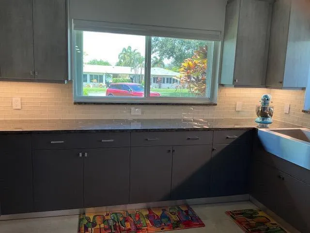 a bathroom with a sink vanity and a large window