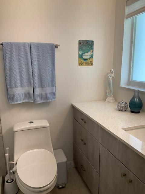 224 Cardinal Lane Delray Beach, FL 33445 - Photo 22 of 38 a white toilet sitting next to a bathroom sink