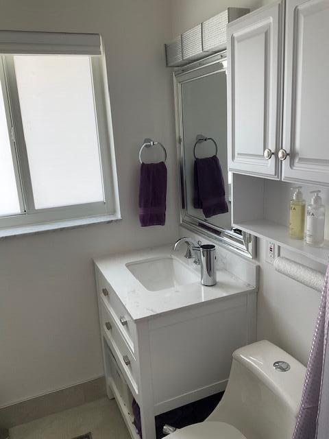 224 Cardinal Lane Delray Beach, FL 33445 - Photo 28 of 38 a bathroom with a sink toilet and mirror