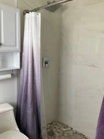 a view of backyard with large trees and plants