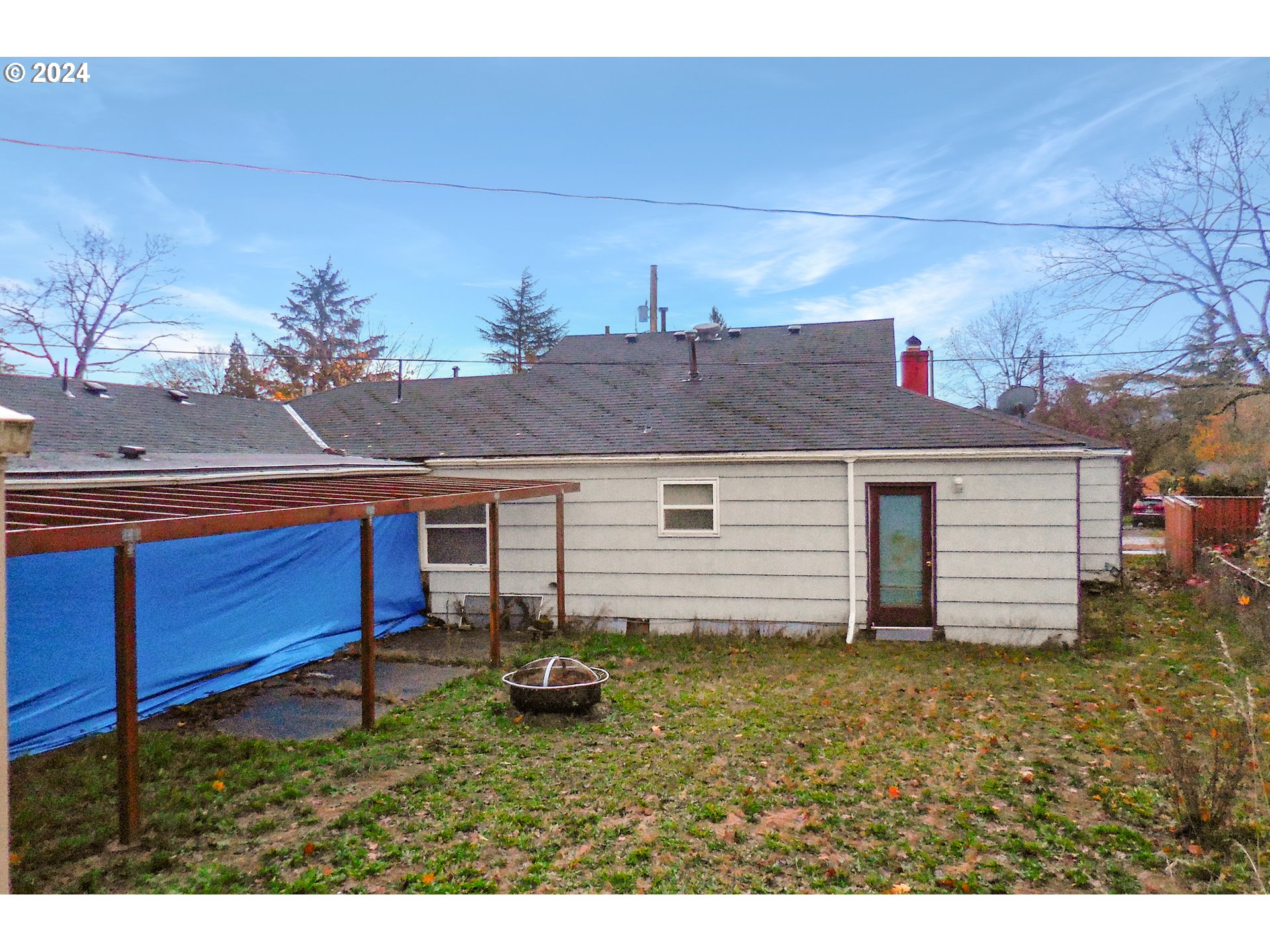 11535 Southeast Boise Street Portland, OR 97266 - Photo 4 of 10 a house view with a backyard space