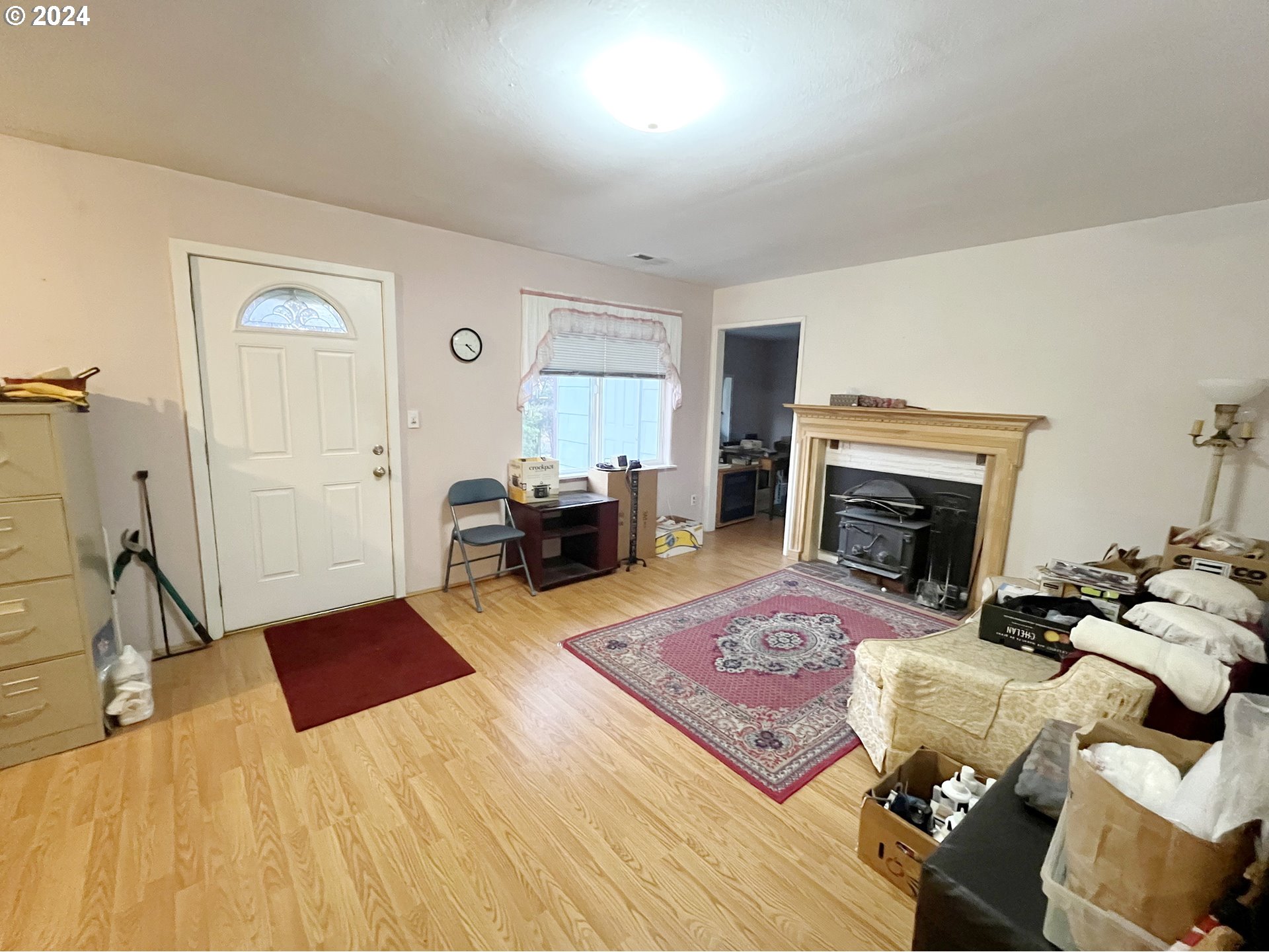 11535 Southeast Boise Street Portland, OR 97266 - Photo 7 of 10 a living room with furniture and a fireplace