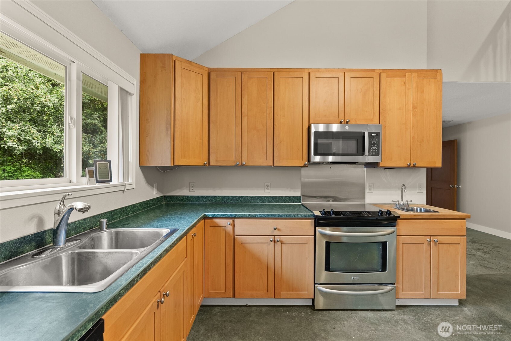 33 Rustemeyer Road Aberdeen, WA 98520 - Photo 16 of 39 a kitchen with granite countertop a sink and a stove top oven