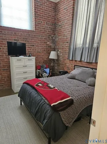 a bedroom with a bed and a chair
