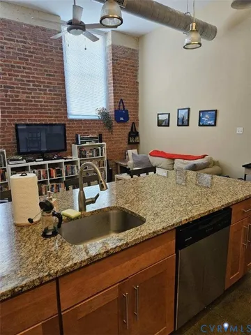 a kitchen with a sink and a wooden floor