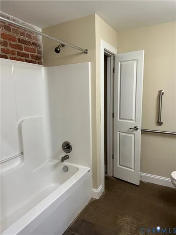 a bathroom with a tub a sink and a mirror