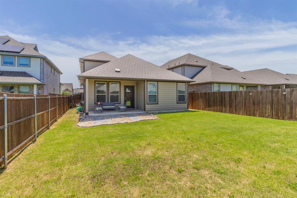 626 Ruthye Lane Pilot Point, TX 76258 - Photo 23 of 27 Back of house with a patio, a fenced backyard, and a shingled roof