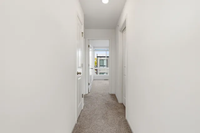 a view of a hallway with a white walls