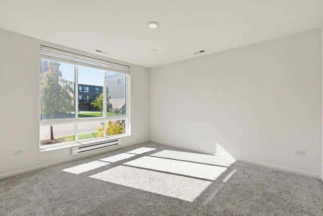 an empty room with large windows