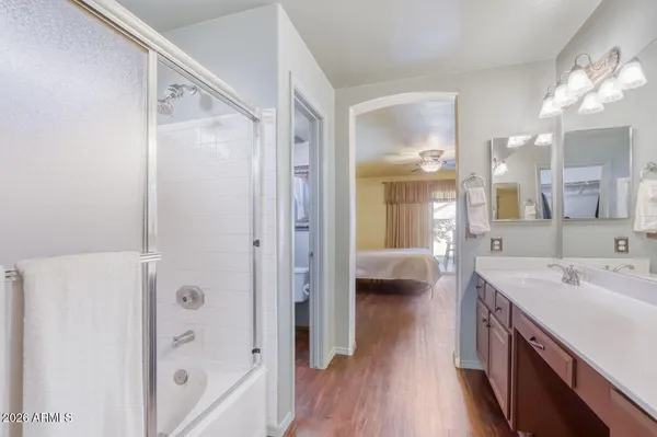a en suite bathroom with a sink a mirror a shower and a bathtub