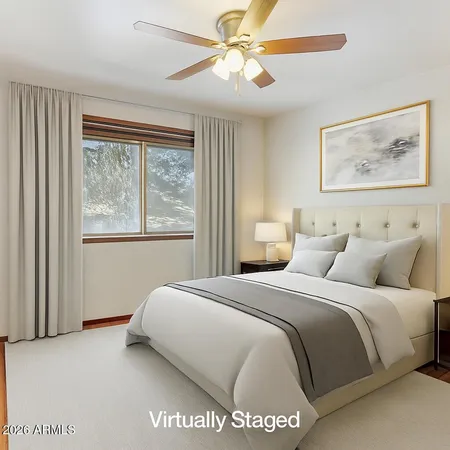 a bedroom with a large bed and a window