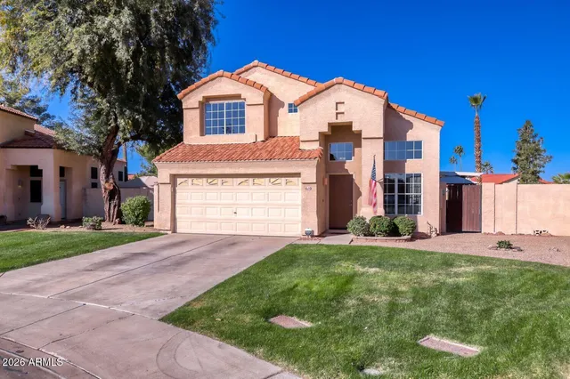 a front view of a house with a yard and garage