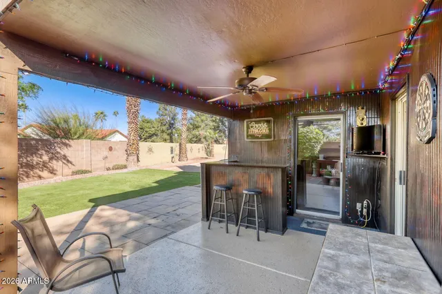 a view of a patio with a table and chairs