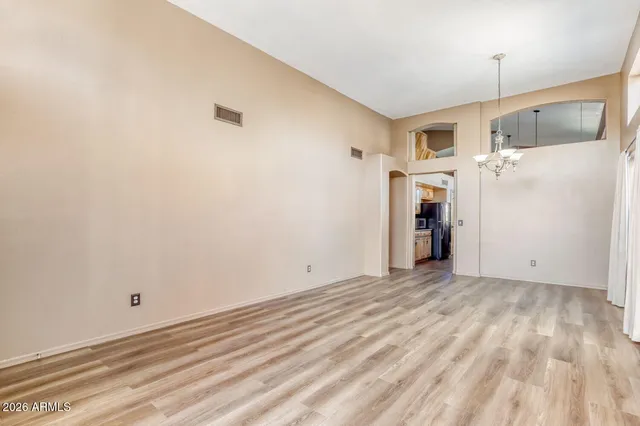 a view of a kitchen with a sink and refrigerator